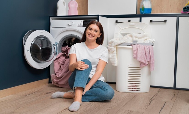 girl sitting near washing machine